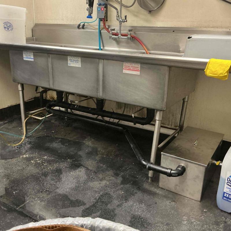 Mini grease interceptor installed on commercial sink plumbing