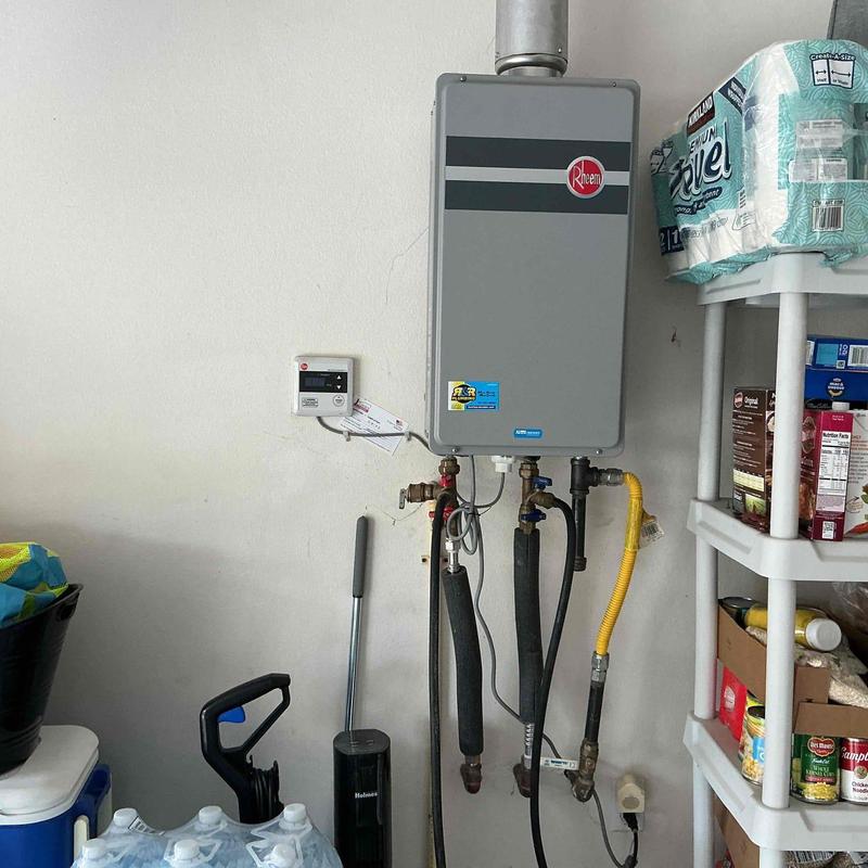 Tankless water heater with flush setup in a garage