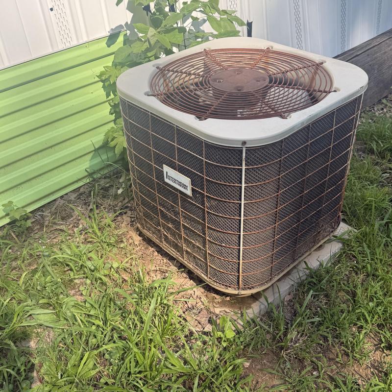 R22 air conditioning unit with rusted fan guard outdoors R22 air conditioning unit with rusted fan guard outdoors