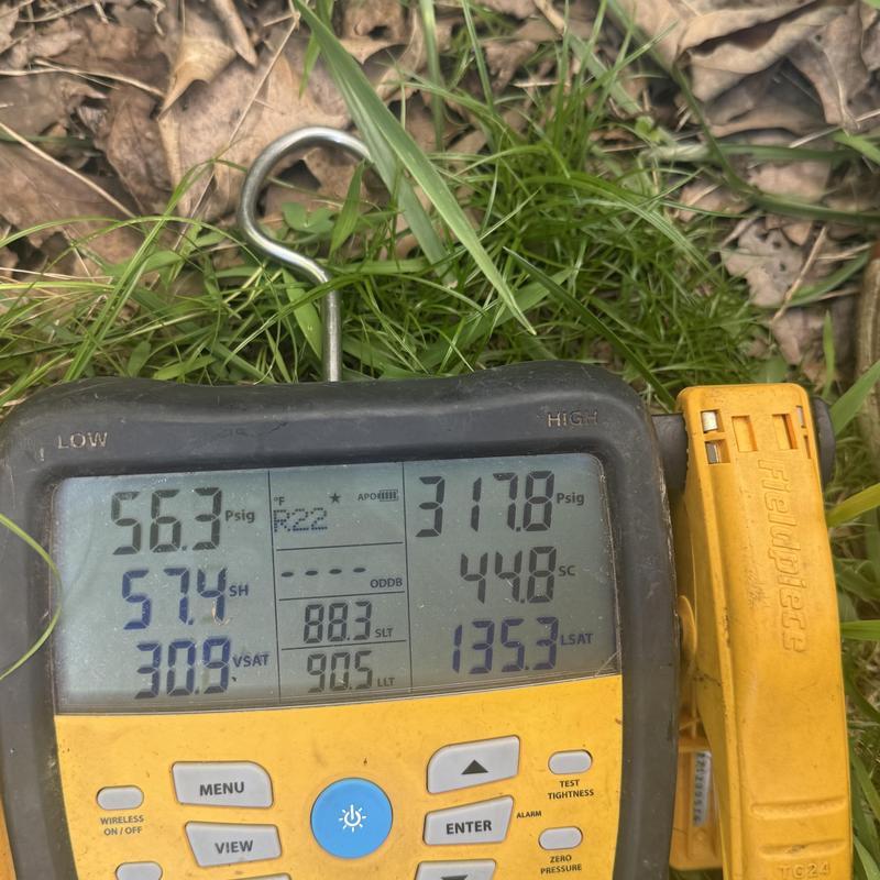 R22 HVAC manifold gauge showing pressure readings in grass R22 HVAC manifold gauge showing pressure readings in grass