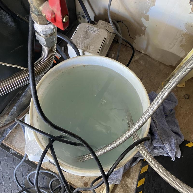 Tankless water heater flushing with bucket and hoses Tankless water heater flushing with bucket and hoses