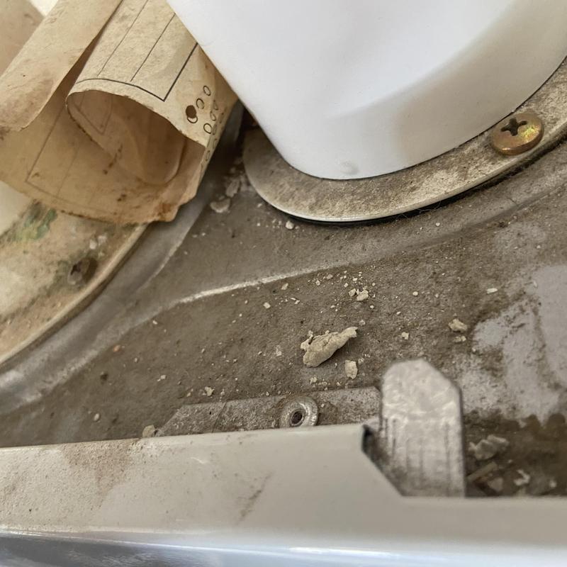 Tankless water heater interior with debris and screws Tankless water heater interior with debris and screws