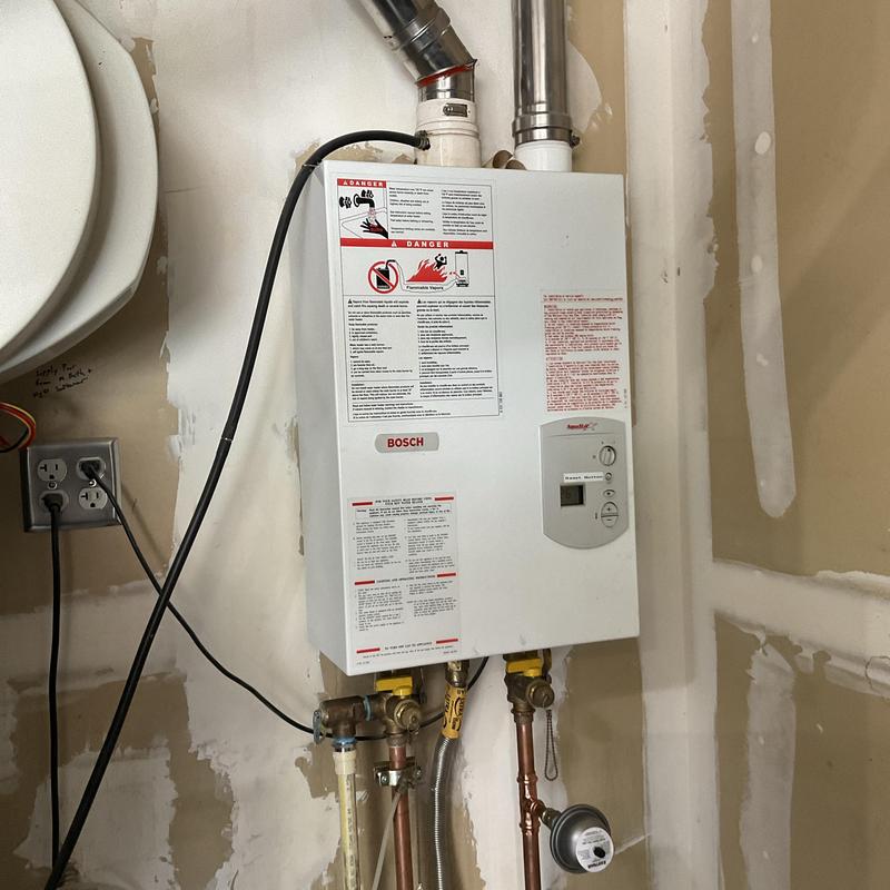 Tankless water heater with connected piping and controls Tankless water heater with connected piping and controls