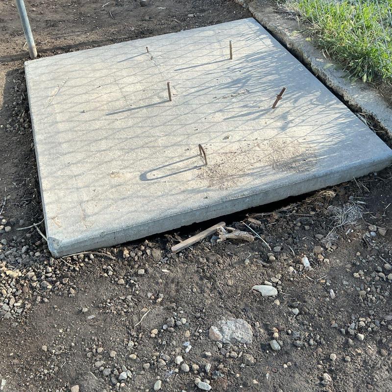 Septic tank concrete lid secured over soil area Septic tank concrete lid secured over soil area