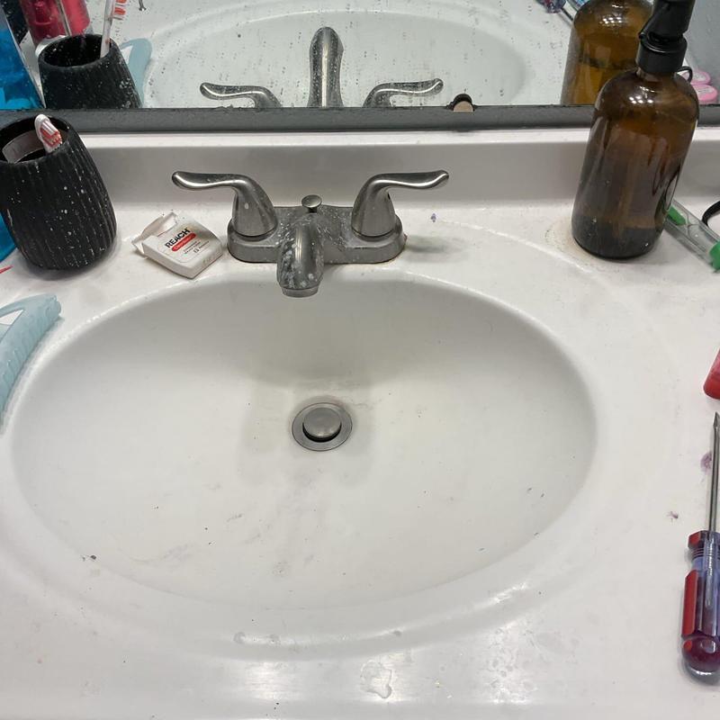 Bathroom sink faucet with cleaning and tools nearby Bathroom sink faucet with cleaning and tools nearby