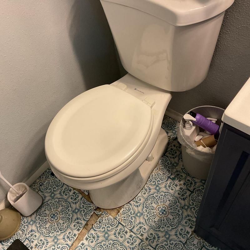 Toilet with sealed base in bathroom corner repair Toilet with sealed base in bathroom corner repair