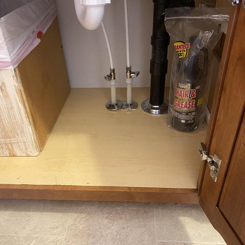 Bathroom sink water supply lines and drain under cabinet