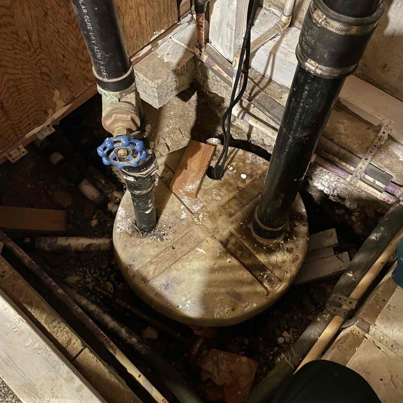 Sewage ejector pump lift tubes reattached in basement tank Sewage ejector pump lift tubes reattached in basement tank