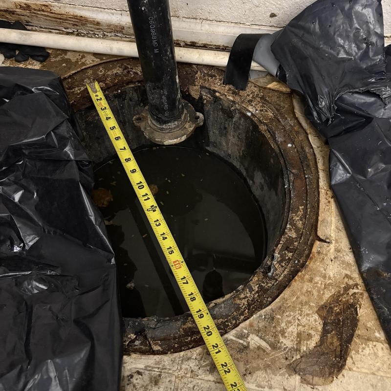 Sump pit with water level and measuring tape