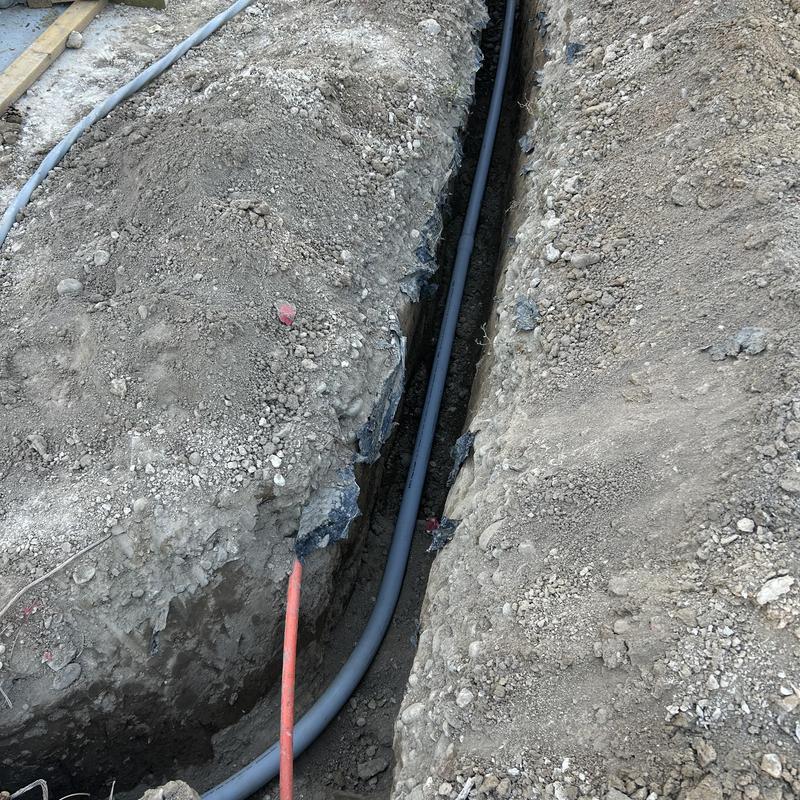 Underground electrical conduit in trench for home service Underground electrical conduit in trench for home service