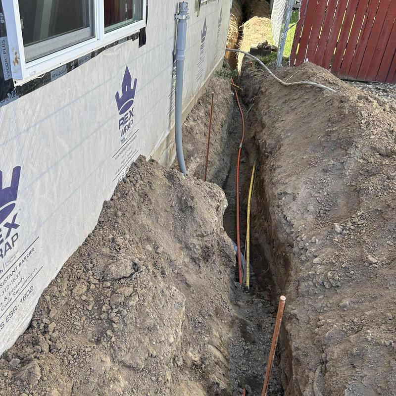 Underground electrical conduit installation beside house wall Underground electrical conduit installation beside house wall