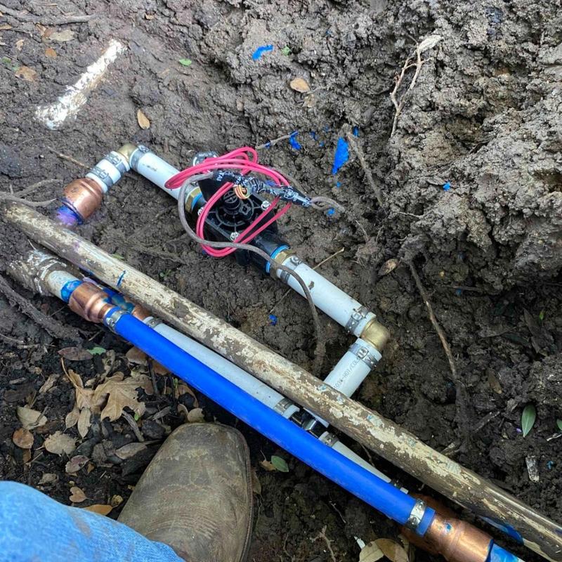 1-inch PVC irrigation line and valve installation in soil