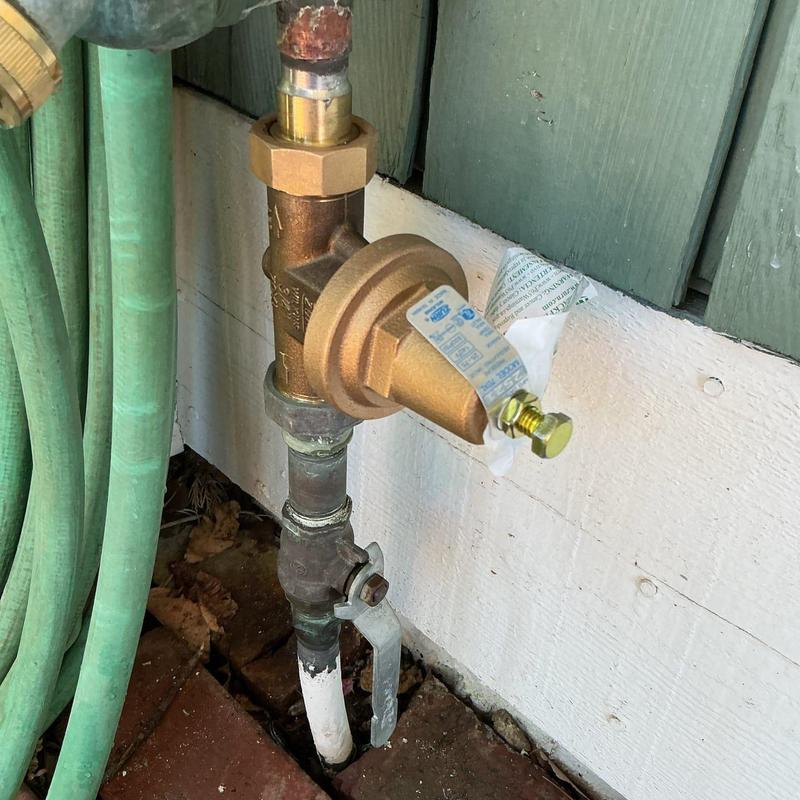 Water pressure reducing valve replacement with hose nearby