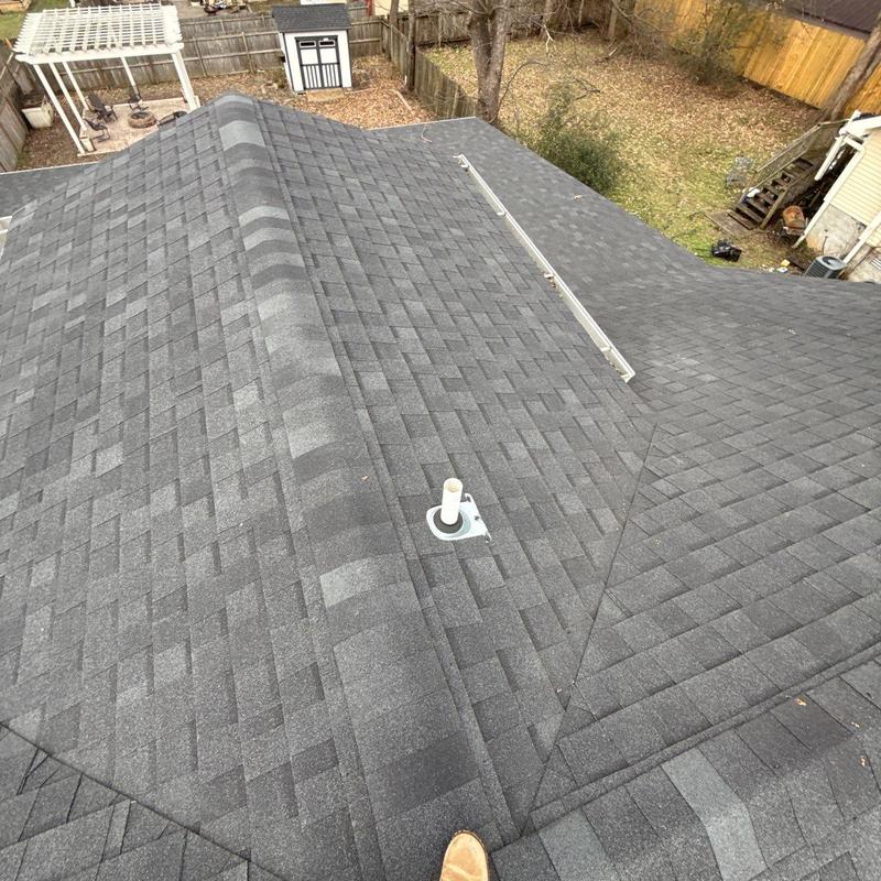 Asphalt shingle roof with ridge vent and pipe flashing