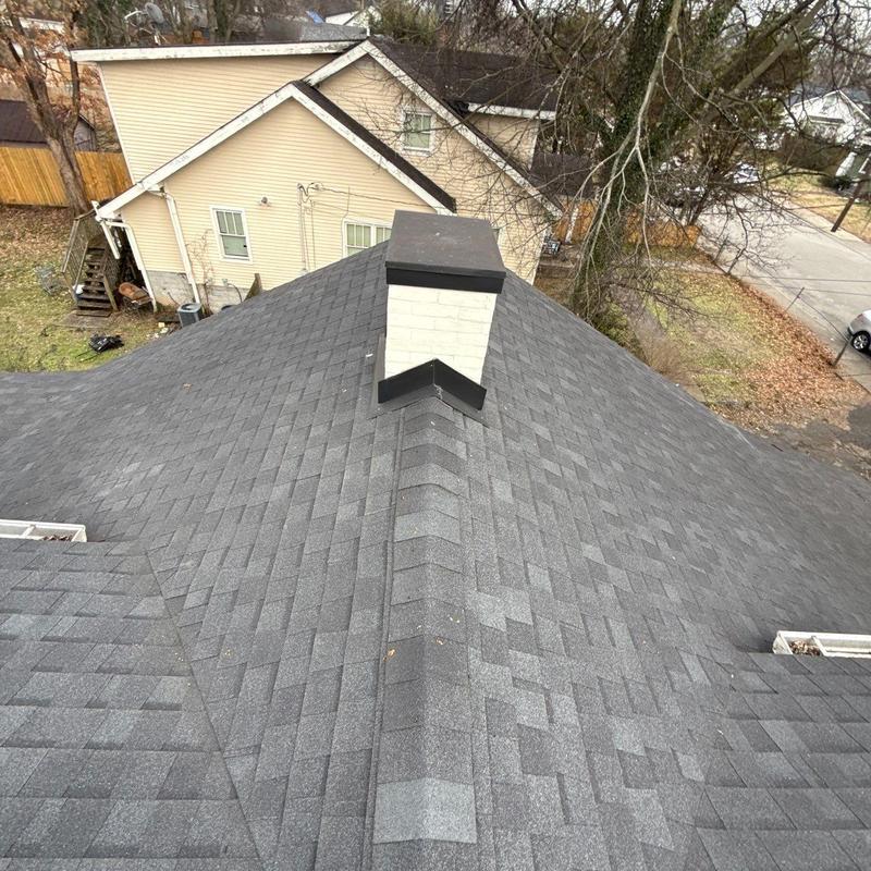 Asphalt shingle roof with chimney and ridge cap detail