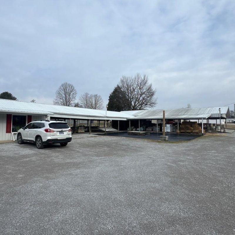 Metal commercial roofing with hail damage and drainage issues