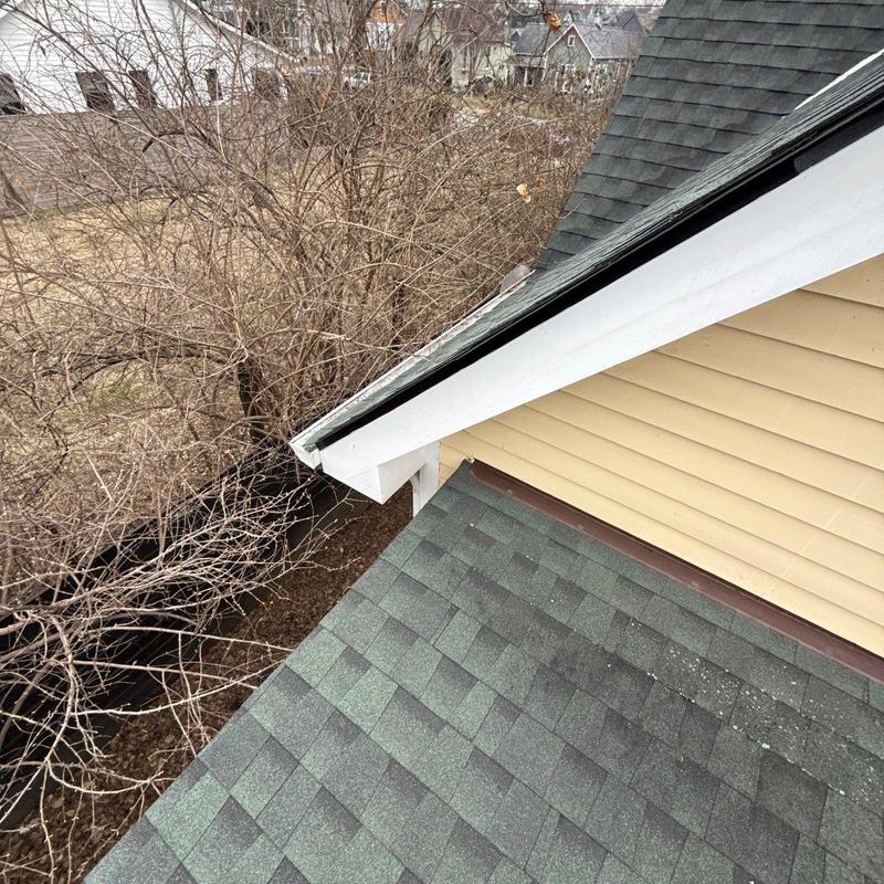 Asphalt shingle roof with hail damage near flashing