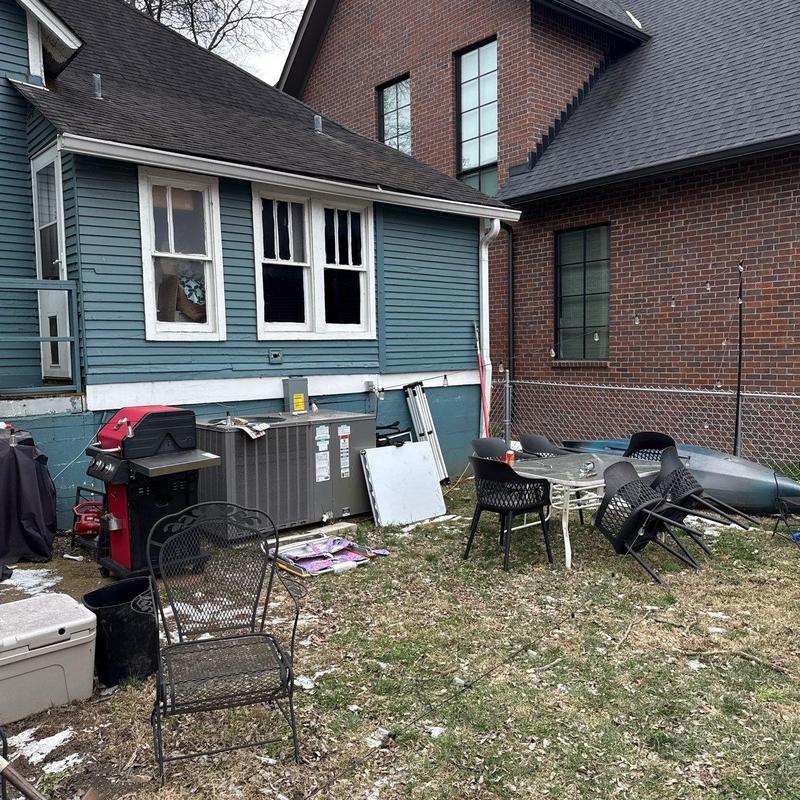 Air conditioning unit beside residential house exterior