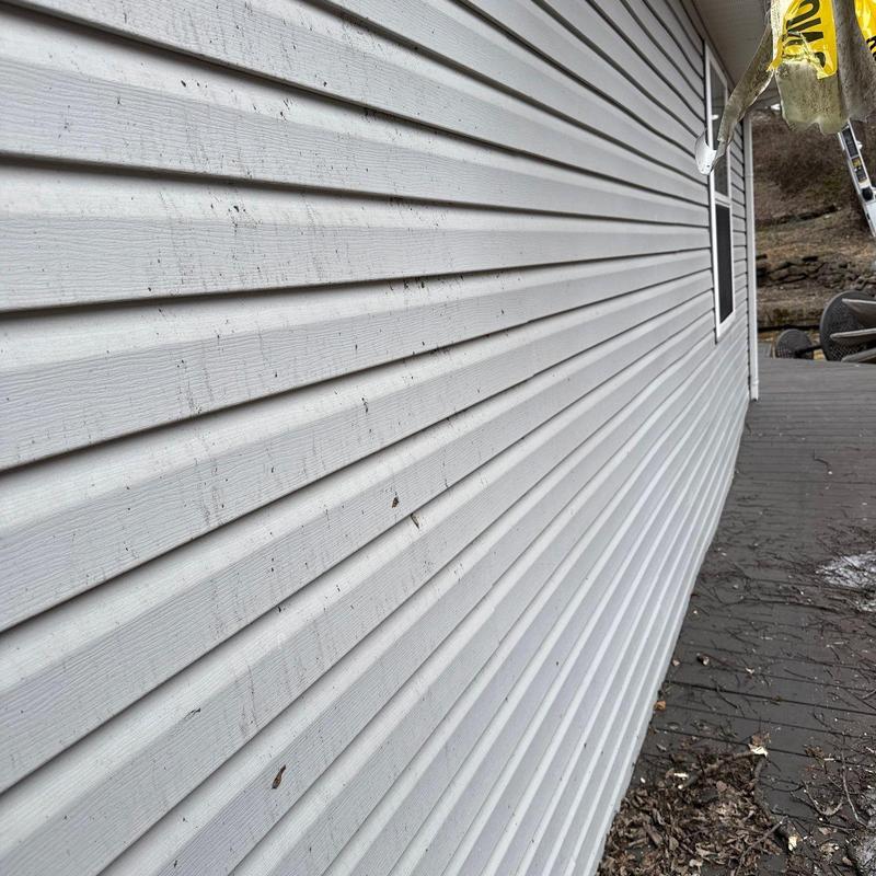Vinyl siding exterior wall with dirt and debris marks