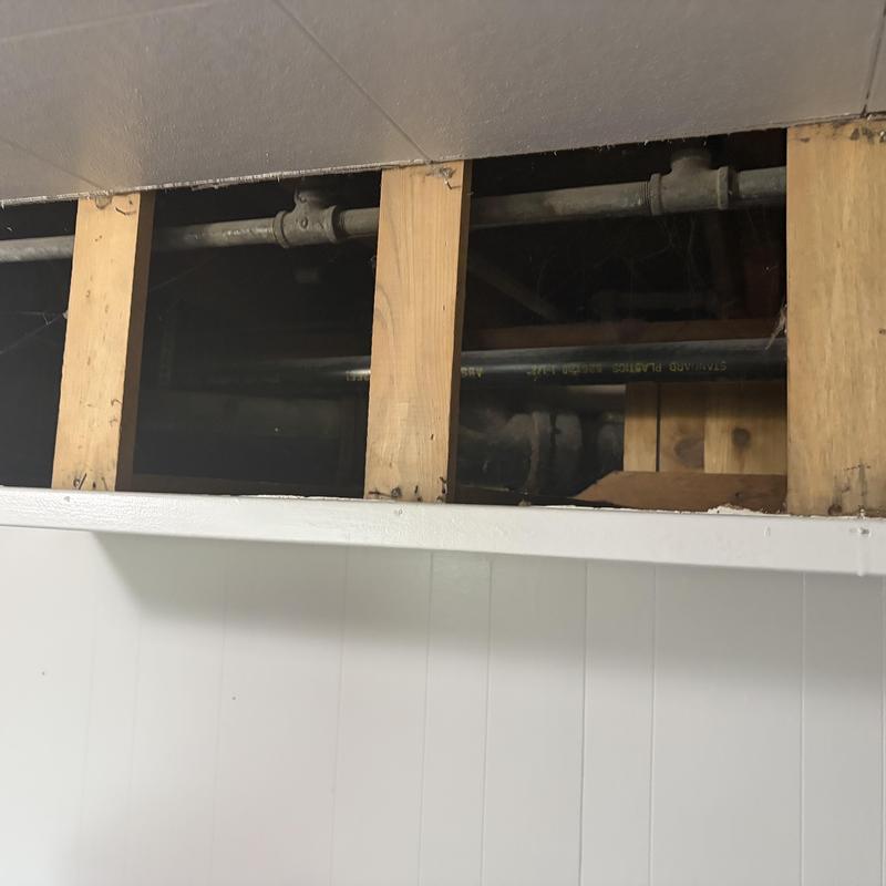 Old plumbing pipes exposed behind wall studs Old plumbing pipes exposed behind wall studs