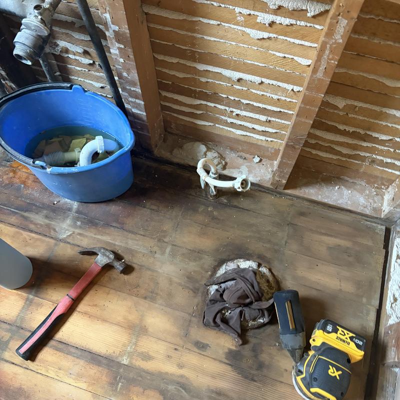 Old plumbing pipes with removed drain and tools Old plumbing pipes with removed drain and tools