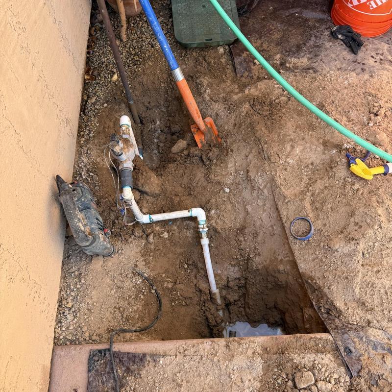 Water line and valve excavation with tools in dirt