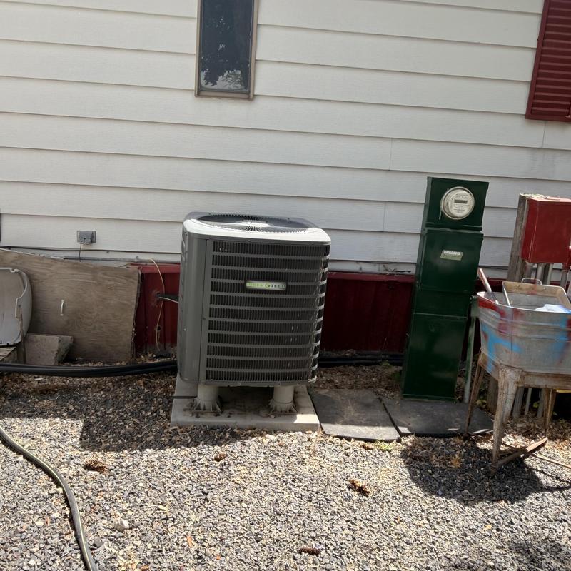 Heat pump unit outside home on concrete pad Heat pump unit outside home on concrete pad