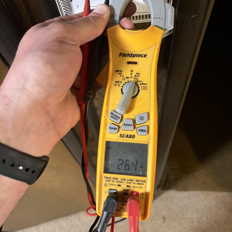 Clamp meter measuring voltage on HVAC system wiring Clamp meter measuring voltage on HVAC system wiring