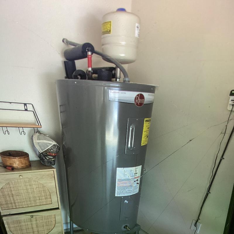 Electric water heater with expansion tank installed Electric water heater with expansion tank installed