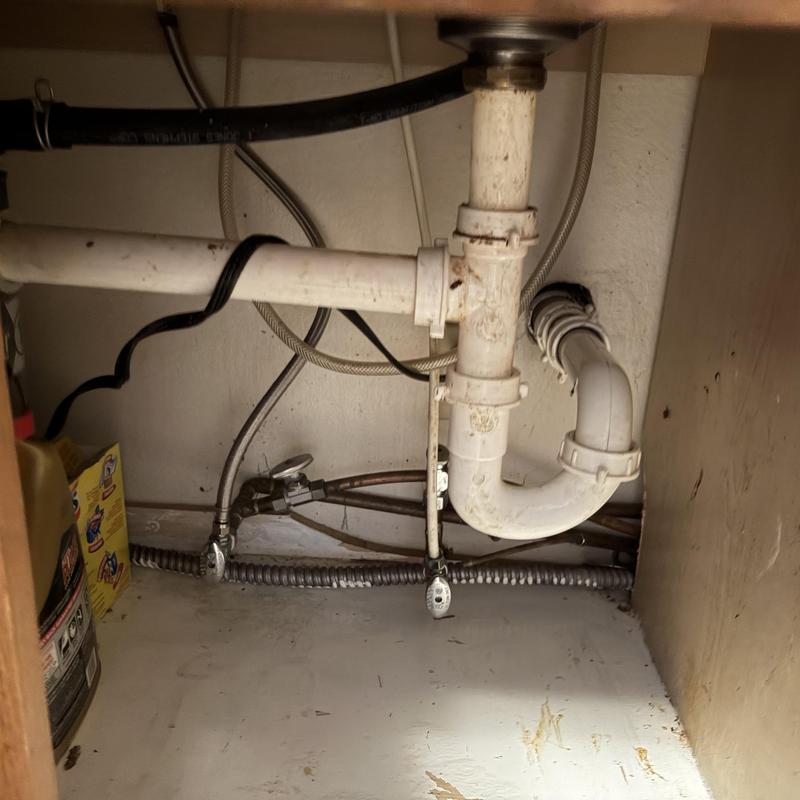 Kitchen sink drain pipes and water lines under cabinet Kitchen sink drain pipes and water lines under cabinet