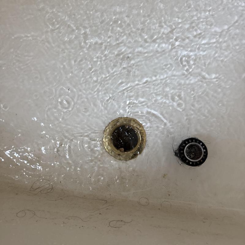 Shower drain clearing with hair removal in bathtub