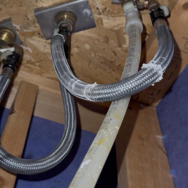 Braided water supply lines under tub plumbing connections