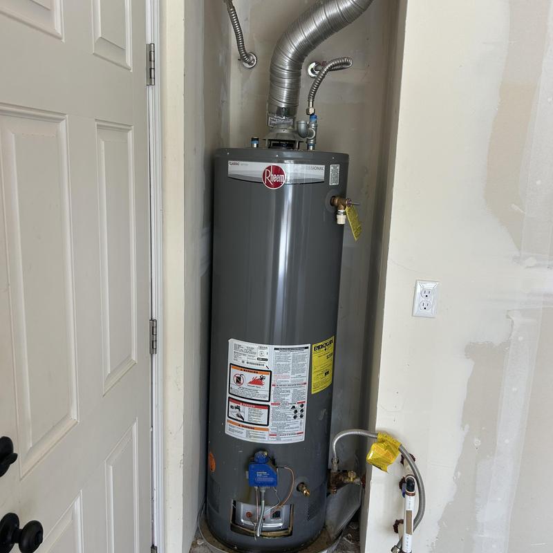 Water heater with vent pipes in utility closet Water heater with vent pipes in utility closet