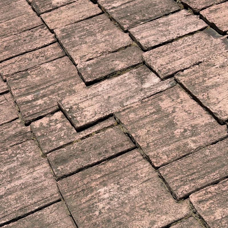 Concrete roof tiles with visible cracks and wear Concrete roof tiles with visible cracks and wear