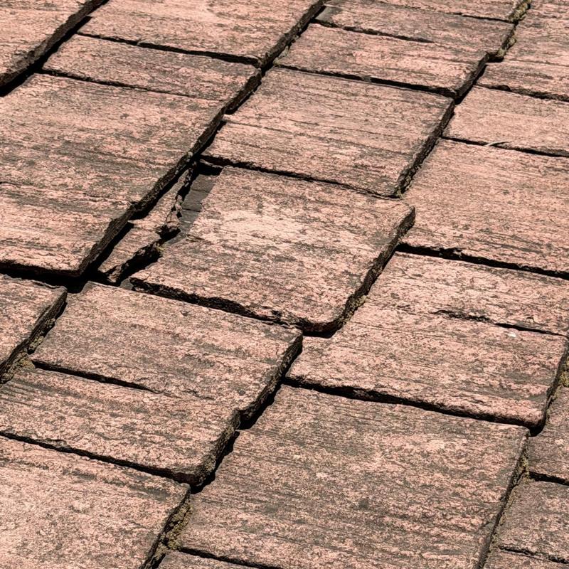 Roof tiles showing cracks and damage close-up Roof tiles showing cracks and damage close-up