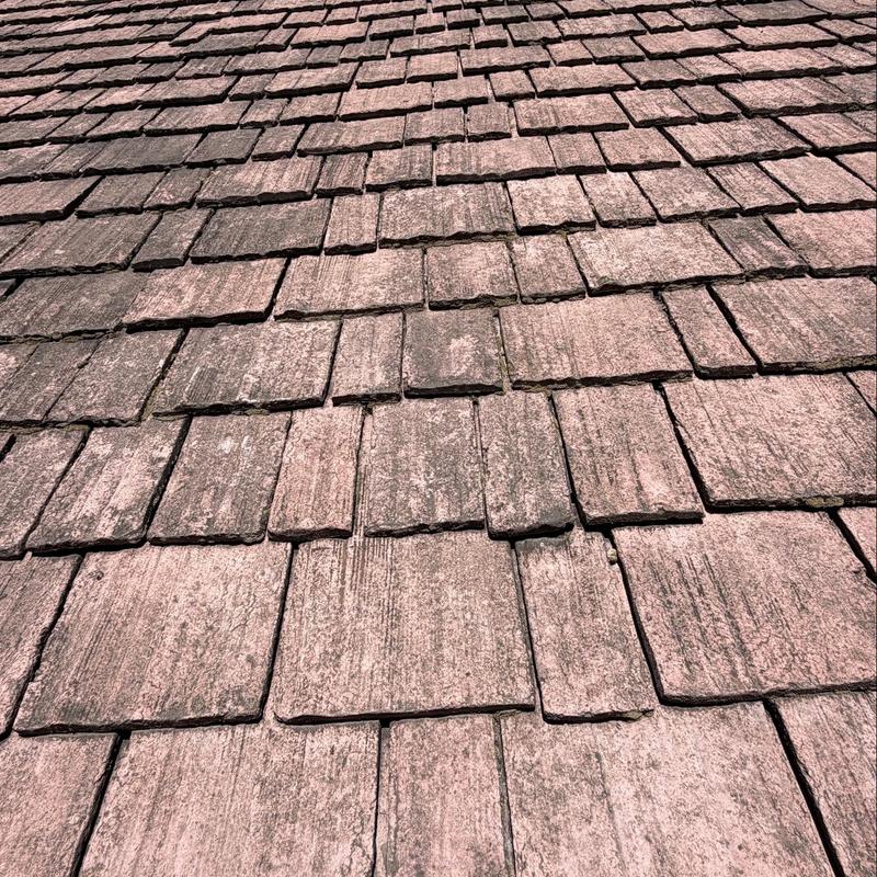 Clay roof tiles with visible cracks and damage Clay roof tiles with visible cracks and damage