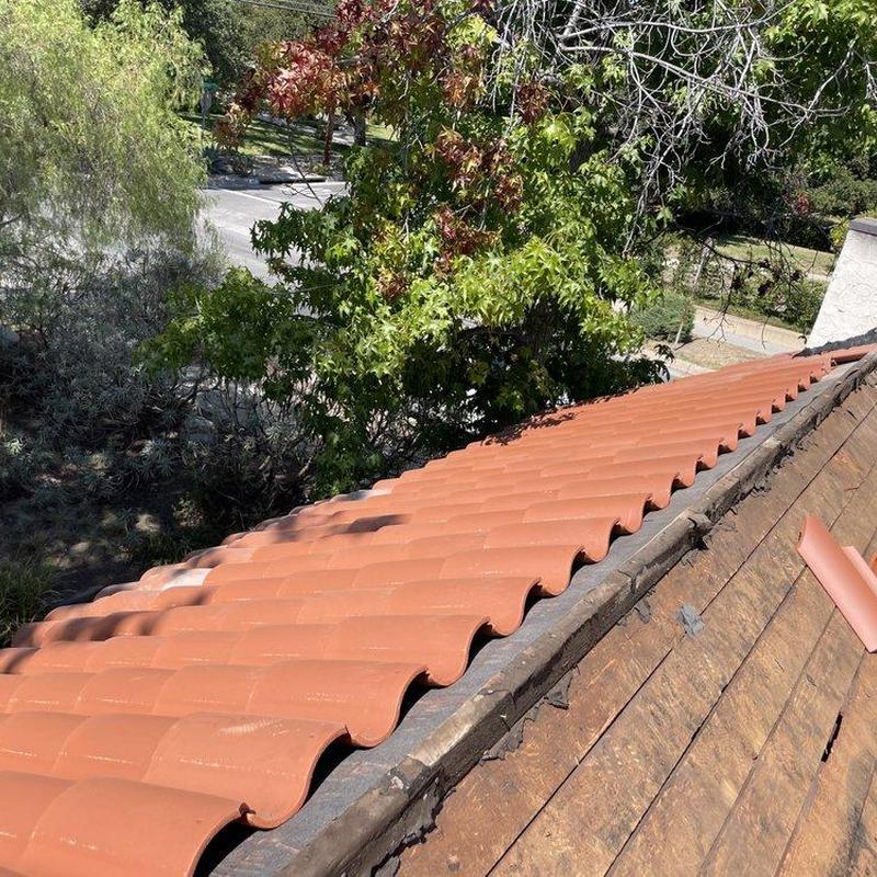 Tile roof ridge with partial tile removal and repair materials Tile roof ridge with partial tile removal and repair materials