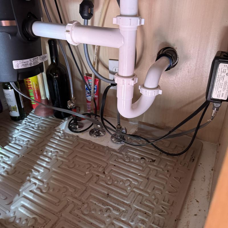 Kitchen sink drain pipes and garbage disposal under cabinet Kitchen sink drain pipes and garbage disposal under cabinet