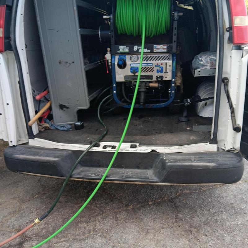 Hydrojetting machine and hoses in plumbing van back