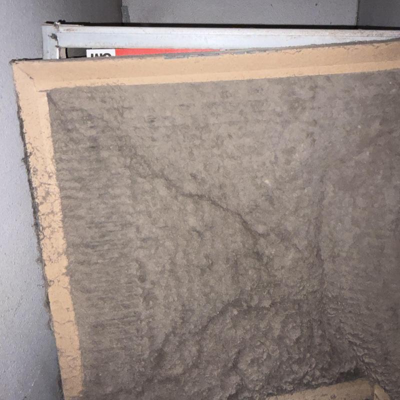 Clogged furnace air filter heavily coated with dust Clogged furnace air filter heavily coated with dust