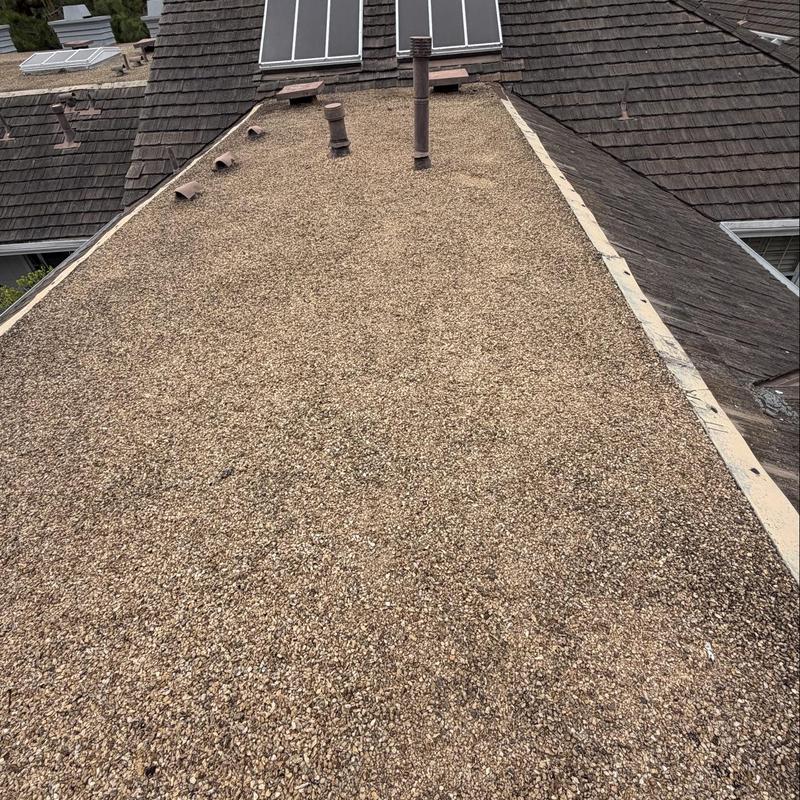Flat roof with gravel surface and vents inspection Flat roof with gravel surface and vents inspection