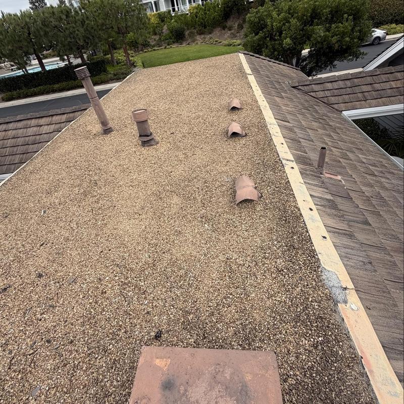 Flat gravel roof with ventilation pipes and flashing Flat gravel roof with ventilation pipes and flashing
