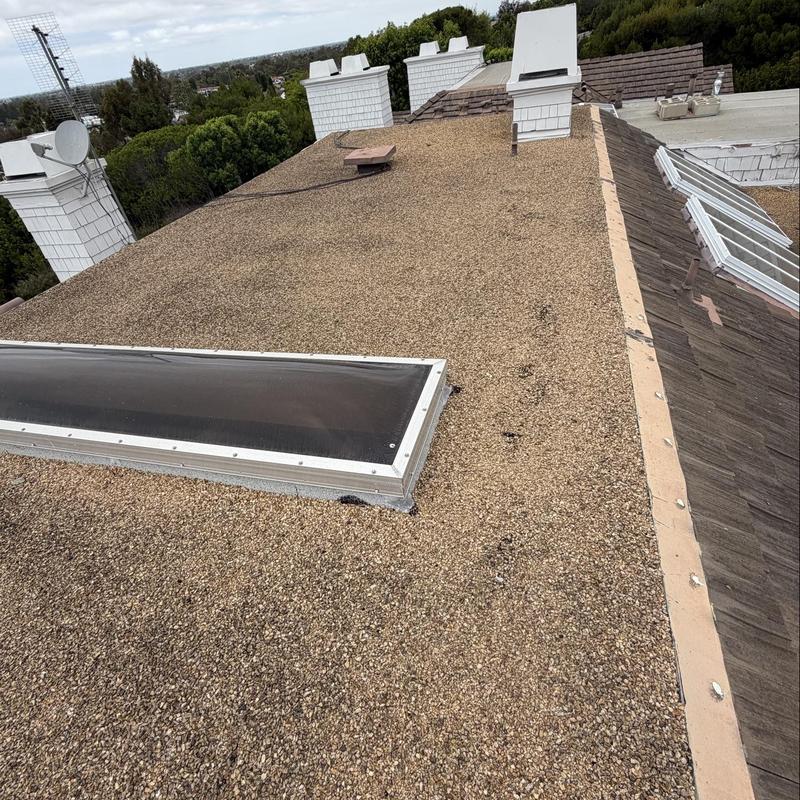 Gravel flat roof with skylight and chimneys Gravel flat roof with skylight and chimneys