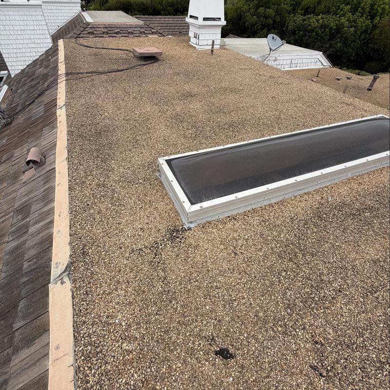 Flat roof with skylight and gravel surface inspection Flat roof with skylight and gravel surface inspection
