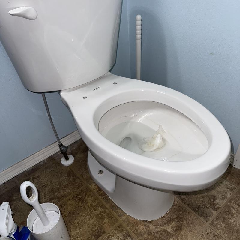 Toilet leaking around base and tank connection in bathroom Toilet leaking around base and tank connection in bathroom