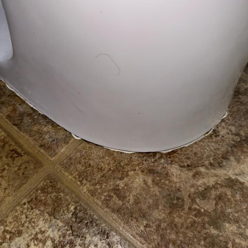 Toilet base caulking on bathroom floor tile Toilet base caulking on bathroom floor tile