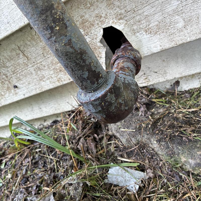 Gas pipe with multiple leak points outside house wall Gas pipe with multiple leak points outside house wall
