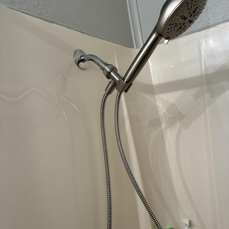 Shower arm and handheld showerhead installation in bathroom Shower arm and handheld showerhead installation in bathroom