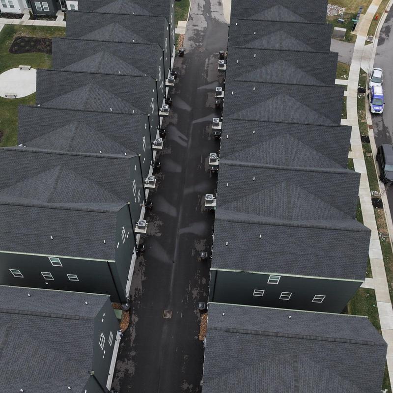 Asphalt shingle roofs on residential townhouses aerial view