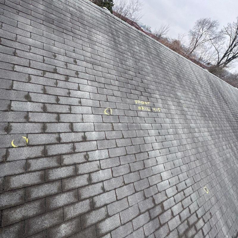 Asphalt shingle roof with hail damage markings